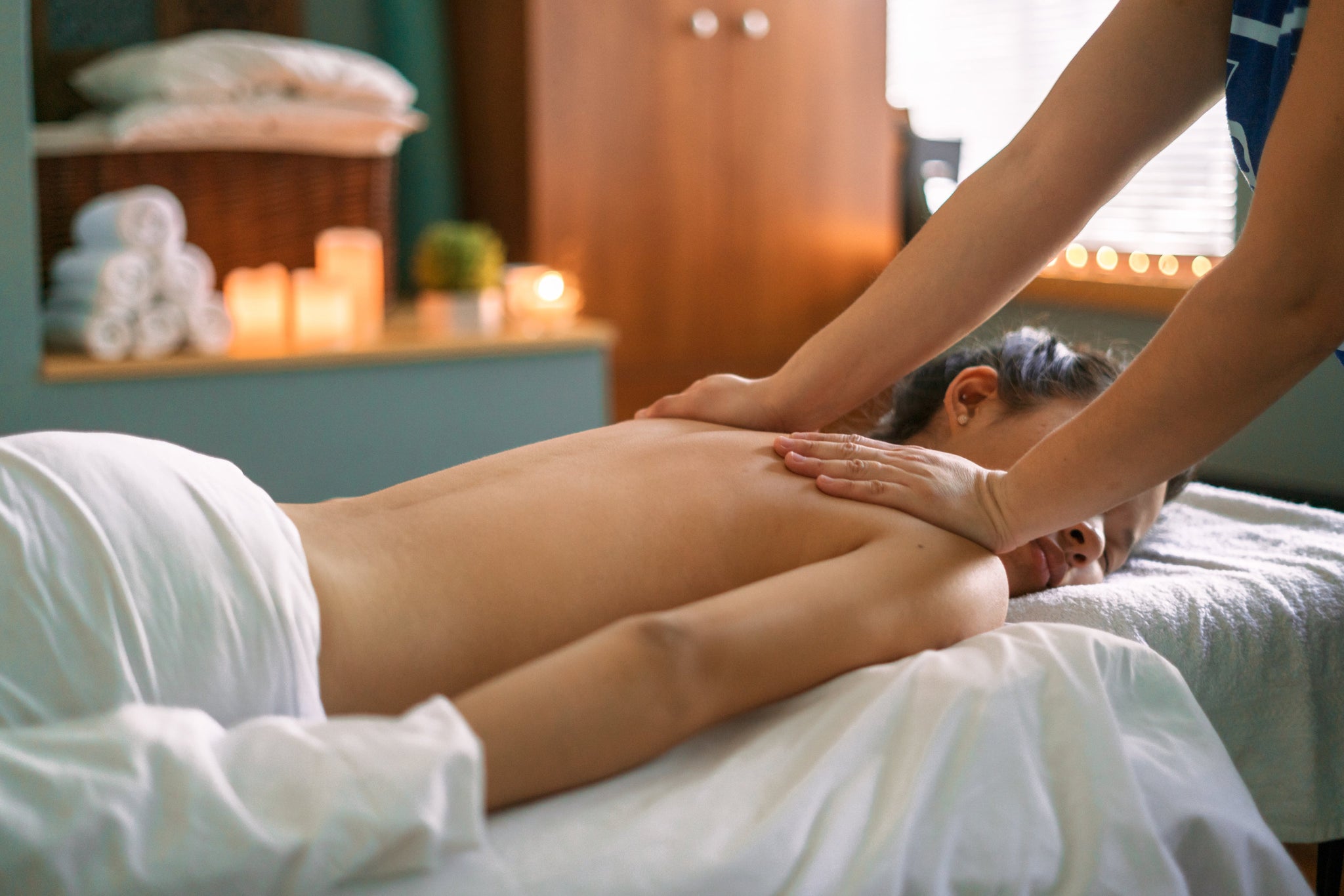 Girl getting a massage with candlelights in the background